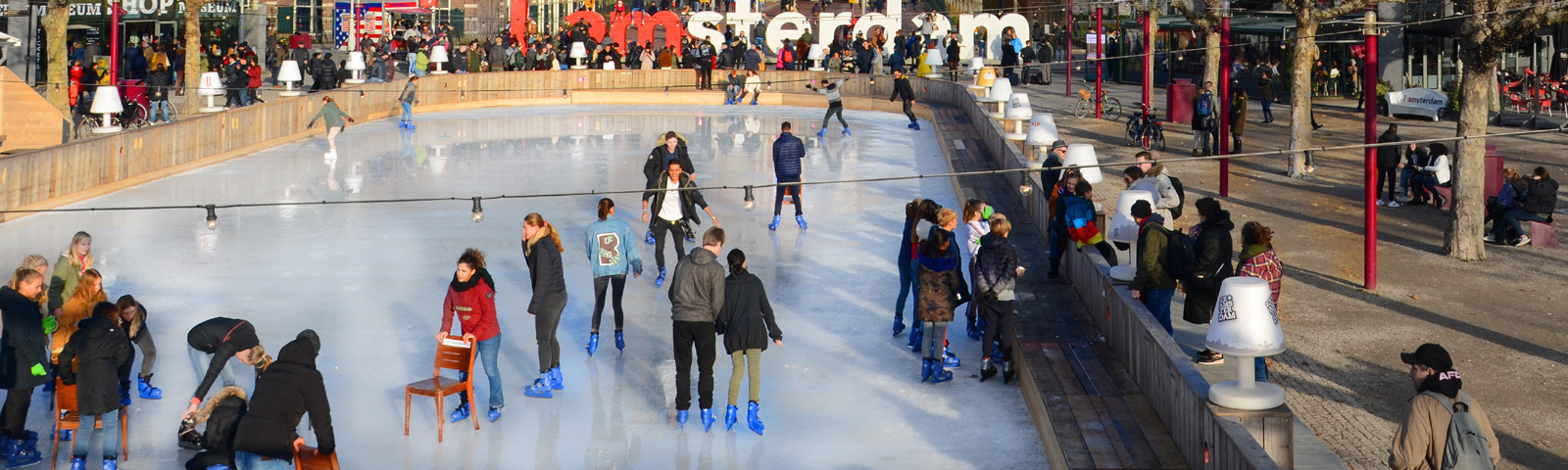 Ice skater gliding in low stance on an outdoor winter rink, showing strong leg drive and stable core with frosty breath in the air.