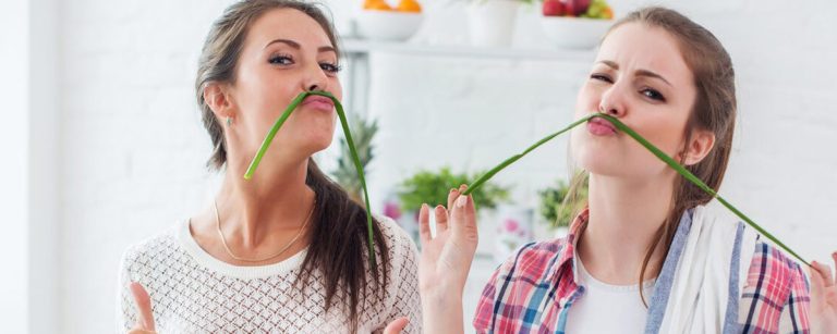 Overhead view of a tidy kitchen counter with chopped vegetables, spice jars, small bowls and labeled meal-prep containers—showcasing simple kitchen hacks.
