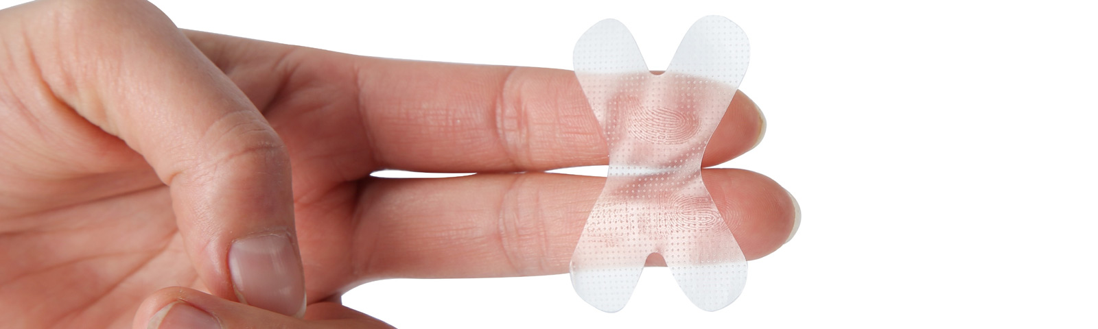 Close‑up of a roll of specialized sleep tape next to a calm bedside scene, illustrating the concept of mouth taping.
