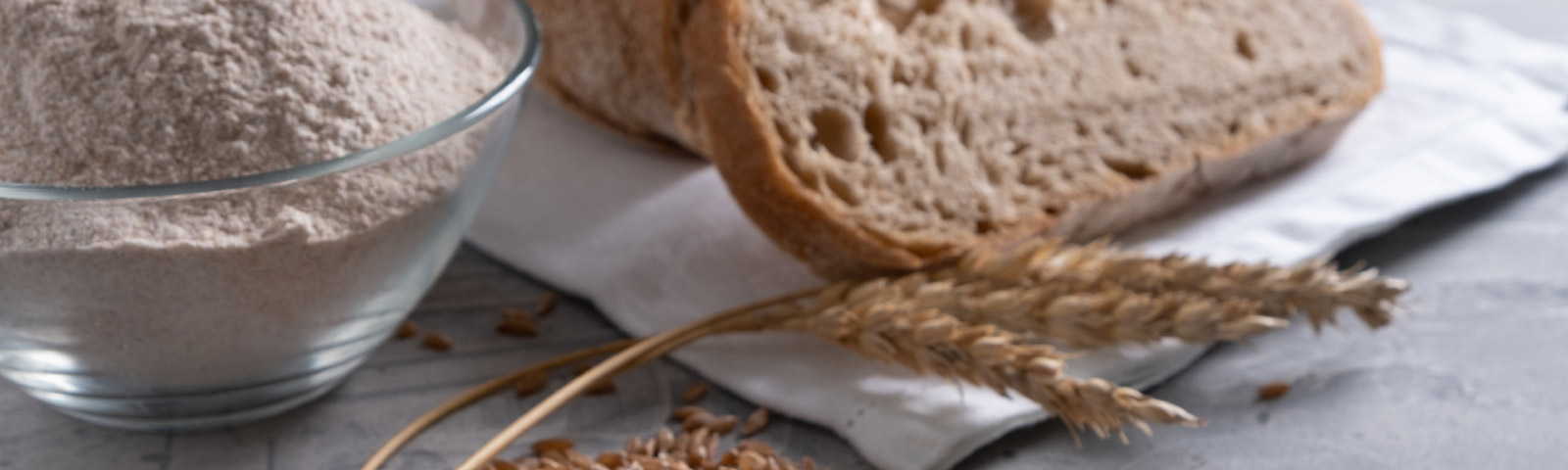 Close-up of a sliced dark brown whole-grain multigrain bread loaf, showing its rich texture and hearty grains.