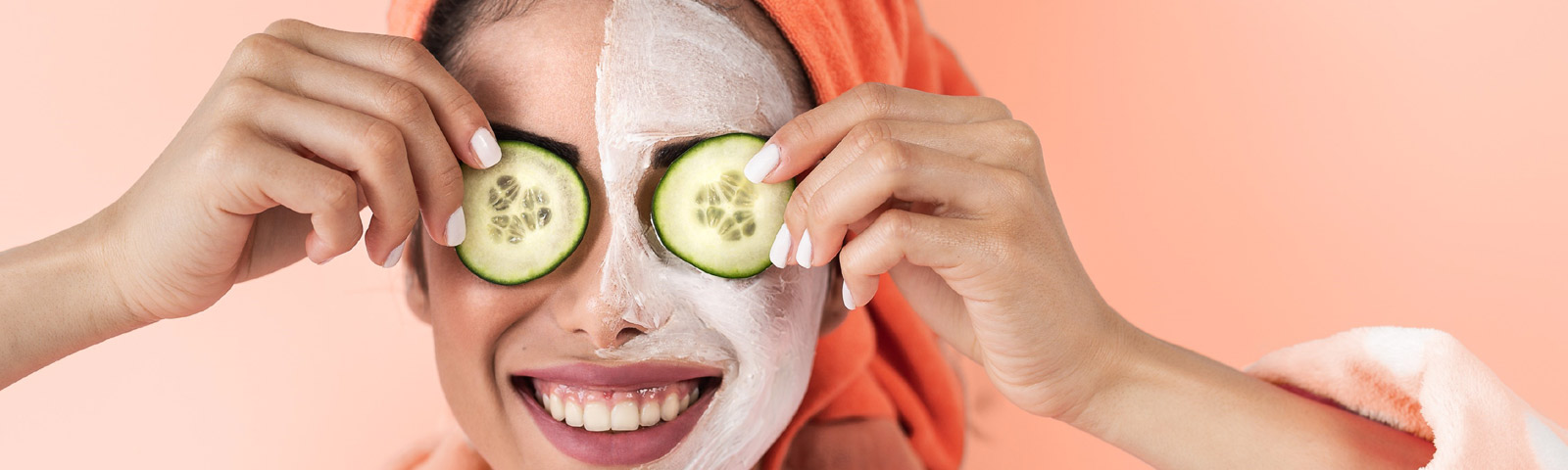 DIY cucumber and mint face mask in a bowl, surrounded by fresh cucumber slices and mint leaves.