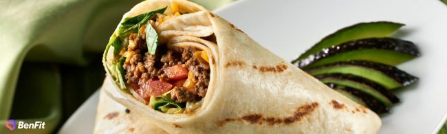 Healthy fast-food style wrap filled with seasoned minced beef, cheese, lettuce, tomato and onions