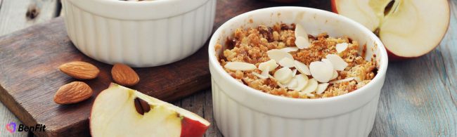Healthy apple crumble in a small baking dish with oats and cinnamon topping