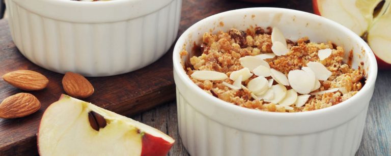 Healthy apple crumble in a small baking dish with oats and cinnamon topping