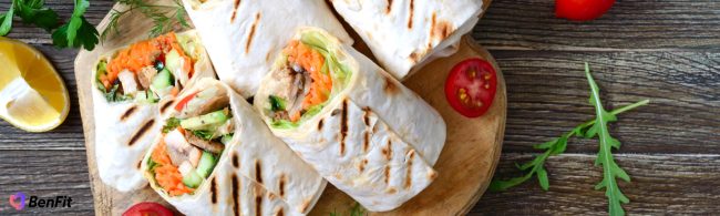 Whole grain wraps filled with hummus, spring vegetables and egg, ready to eat